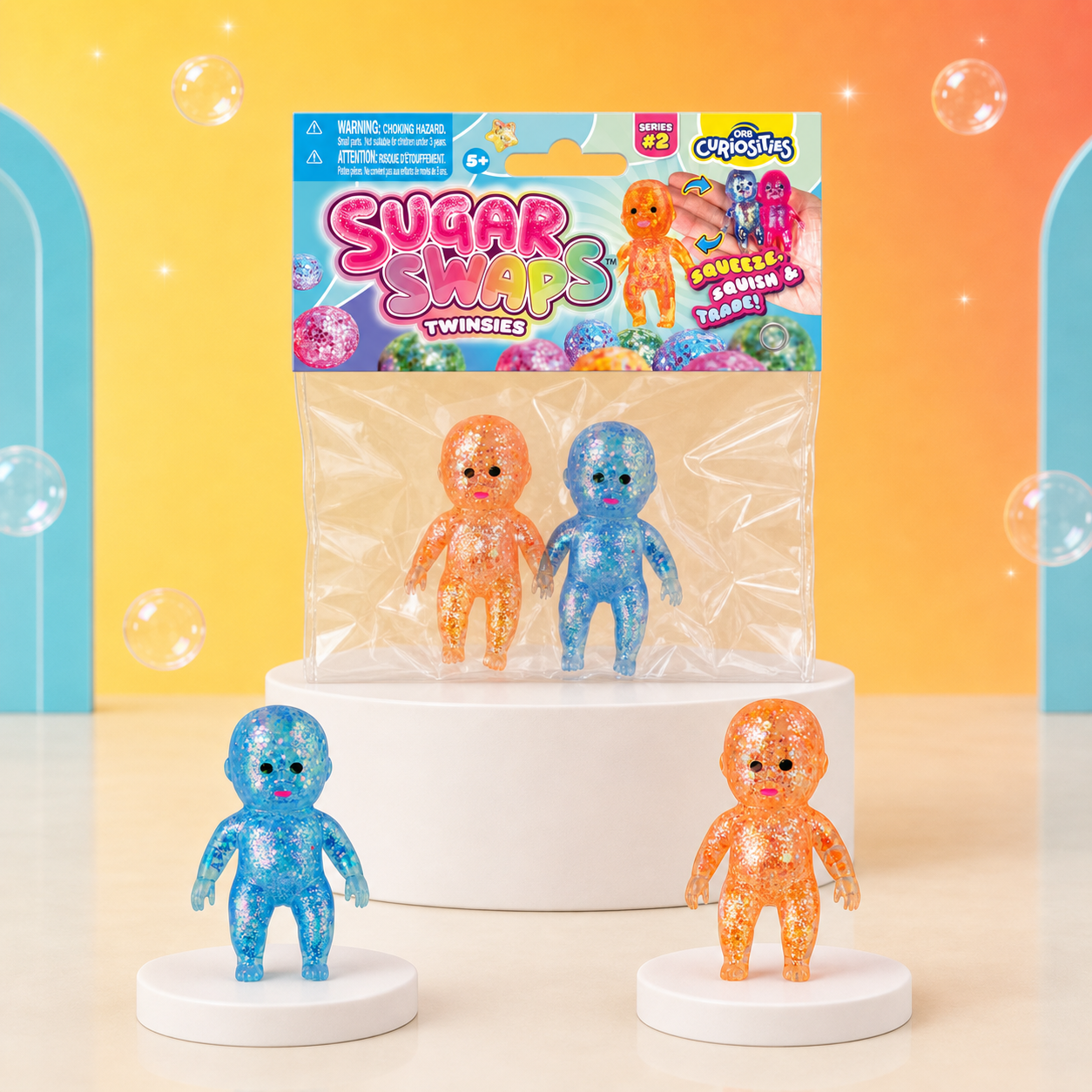 ORB Sugar Swaps Twinsies package with blue and orange glitter babies on Citrus Pop podiums