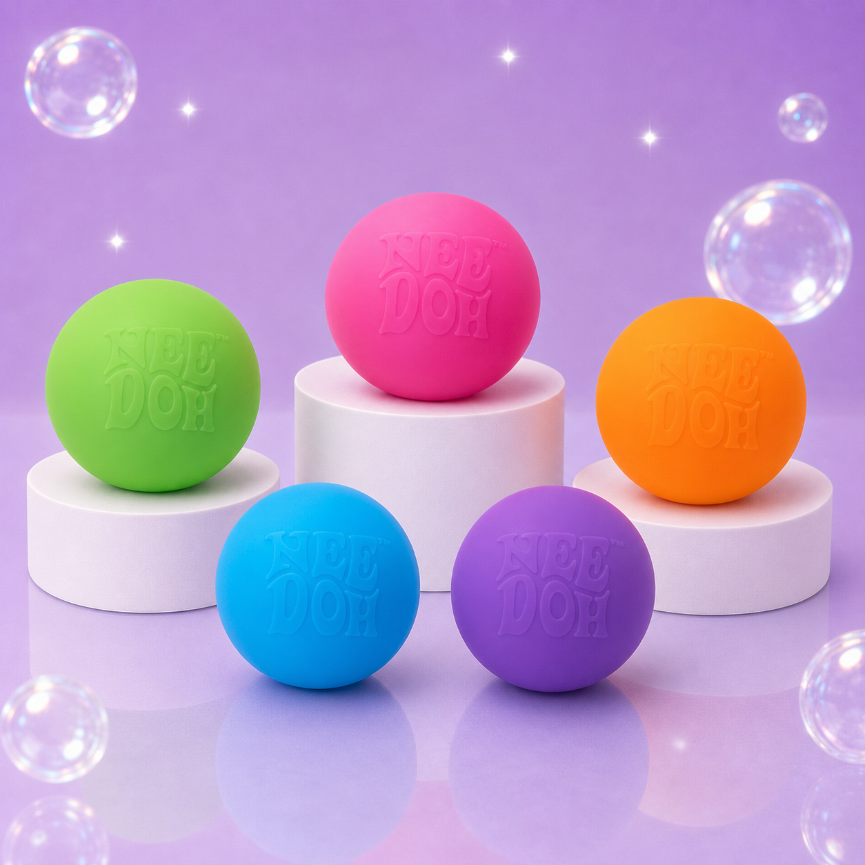 Pink, blue, orange, green and purple NeeDoh Groovy Glob squishy balls on white podiums.