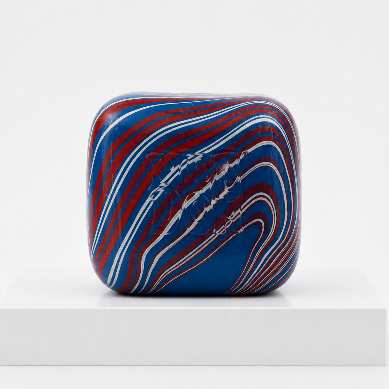 Red white and blue NeeDoh Nice Cube Swirlin USA squishy front-facing on a white podium
