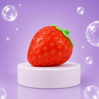 Red Sunny Days Squeeezy Strawberry sensory fidget toy displayed on a white podium.