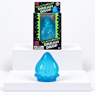 Blue NeeDoh Galactic Glow Dream Drop toy in front of its box on white display blocks