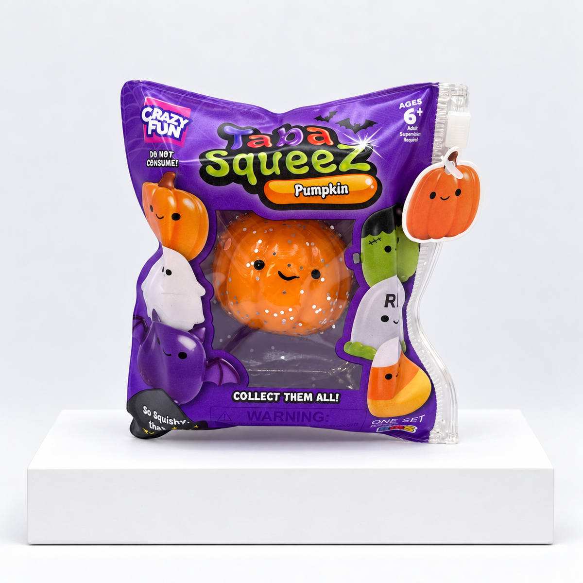 Purple Halloween Taba Squeez bag with orange pumpkin-shaped toy inside