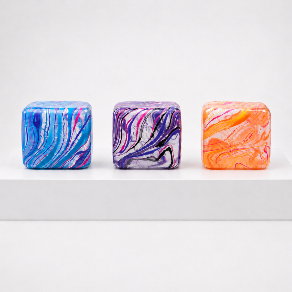 Three blue, purple and orange marbled NeeDoh Nice Berg Swirl cubes without boxes