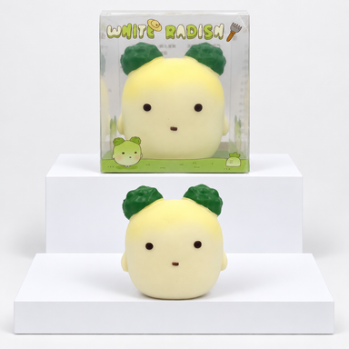 Pale yellow Nunu radish character with dark green leaves pictured beneath its box