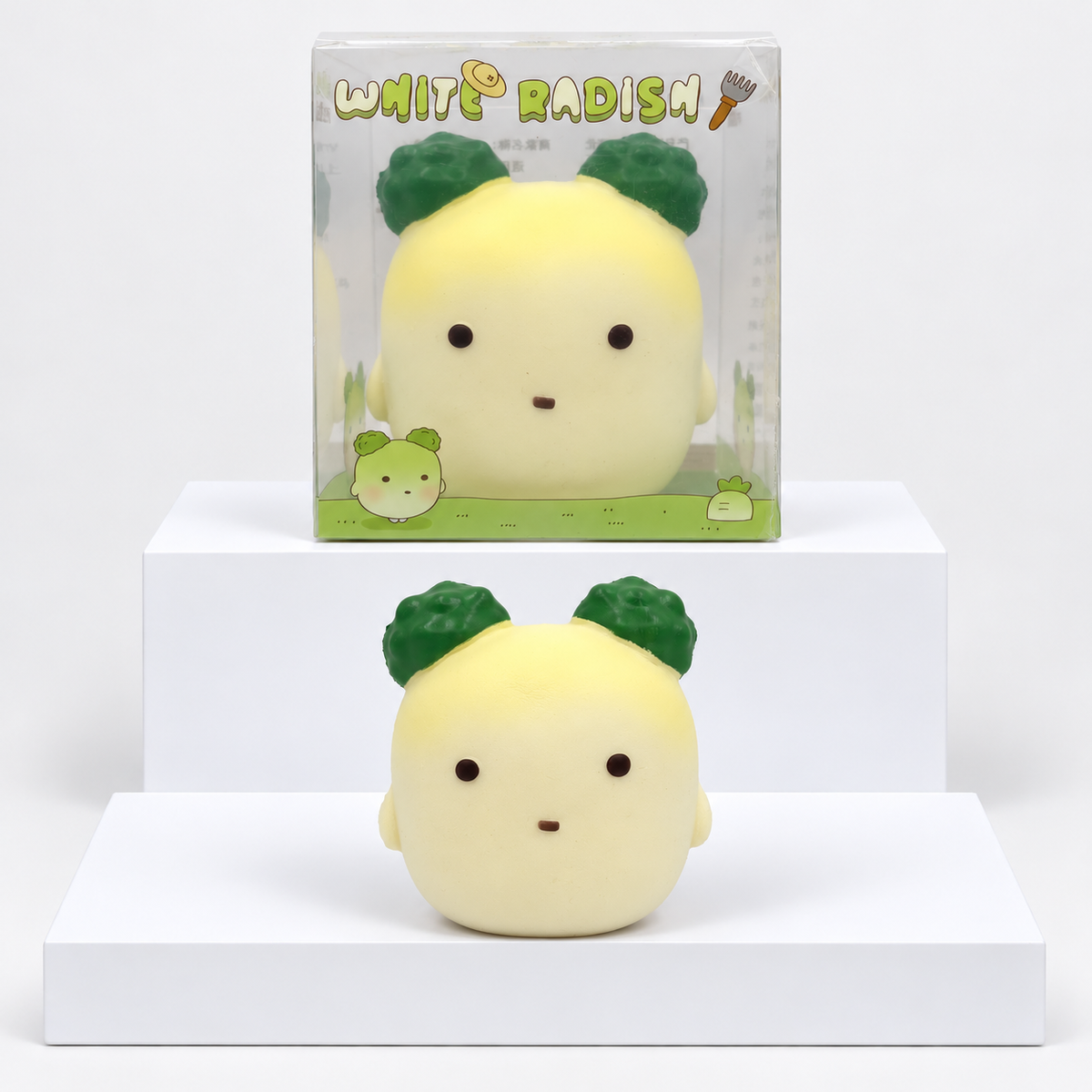 Pale yellow Nunu radish character with dark green leaves pictured beneath its box