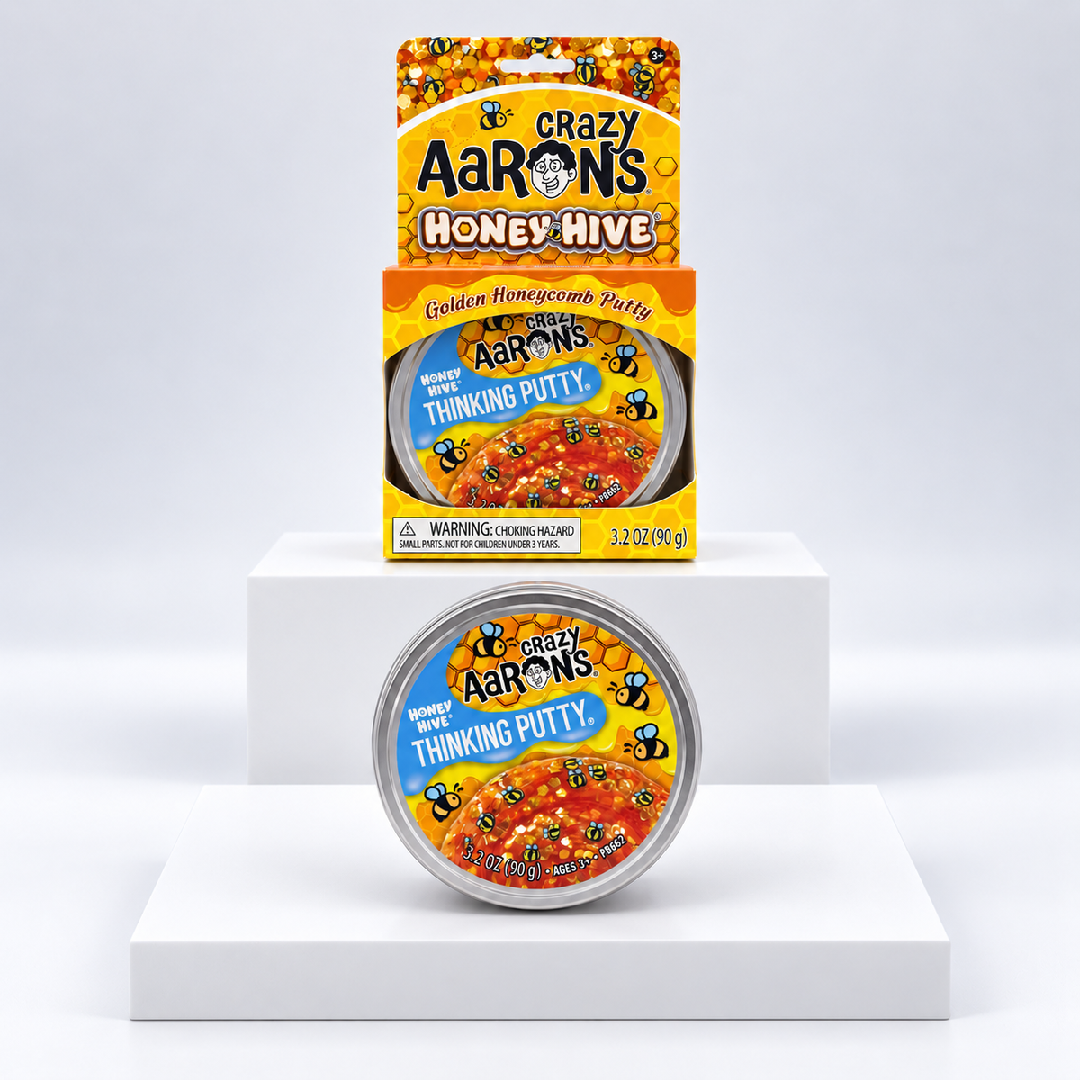 Crazy Aaron's Honey Hive Thinking Putty tin and yellow display box, front view