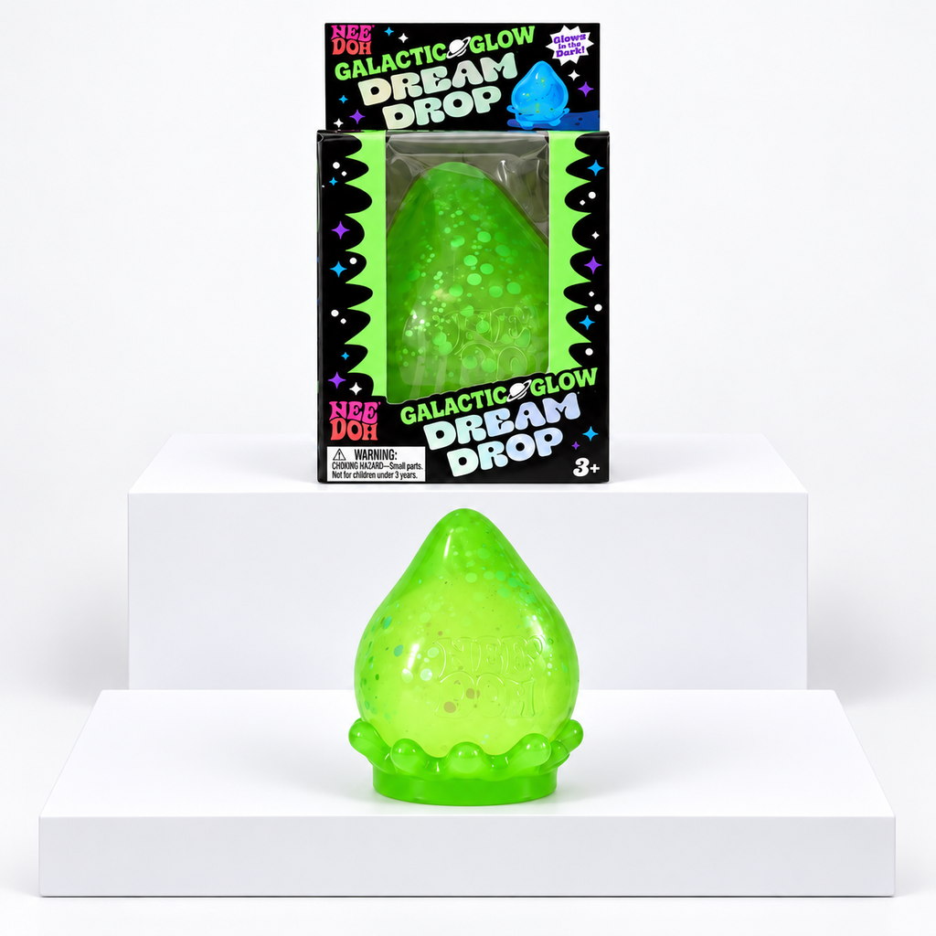 Green NeeDoh Galactic Glow Dream Drop toy in front of its box on white display blocks