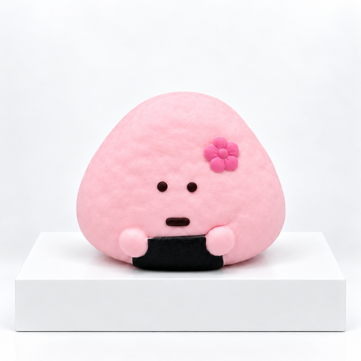 Pink Dudo rice-ball character with flower, unboxed front view