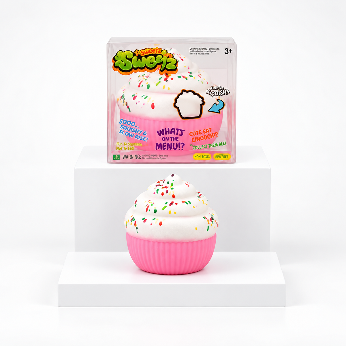 White sprinkle cupcake squishy with pink base displayed in front of its box