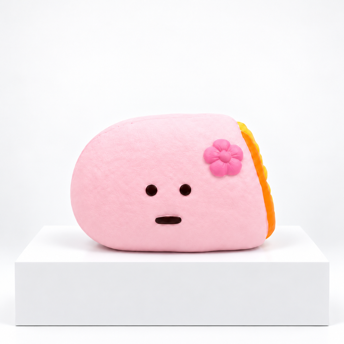 Pink Dudo crepe-shaped character with flower, unboxed angled view