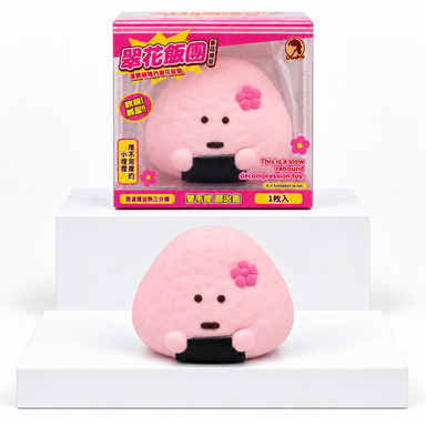 Pink Dudo rice-ball character with flower and retail box behind it