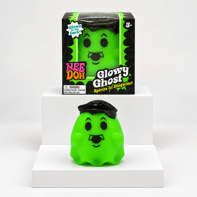 Green NeeDoh Glowy Ghost toy in front of its box on white display blocks
