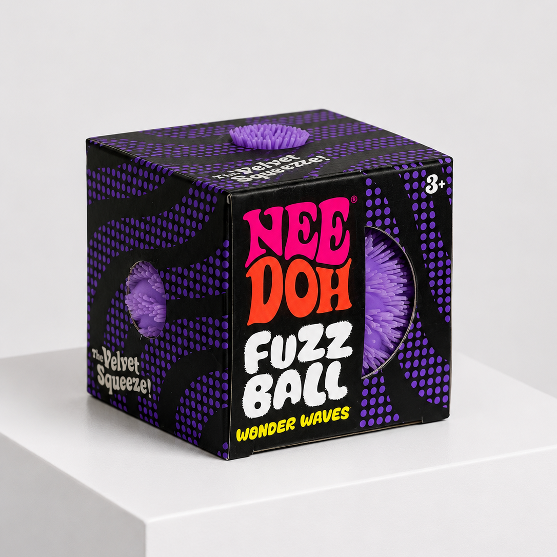 A cube-shaped product box for Nee Doh Fuzz Ball Wonder Waves, featuring a black and purple patterned design with bold pink, orange, and white lettering, displayed on a white pedestal against a light gray background.