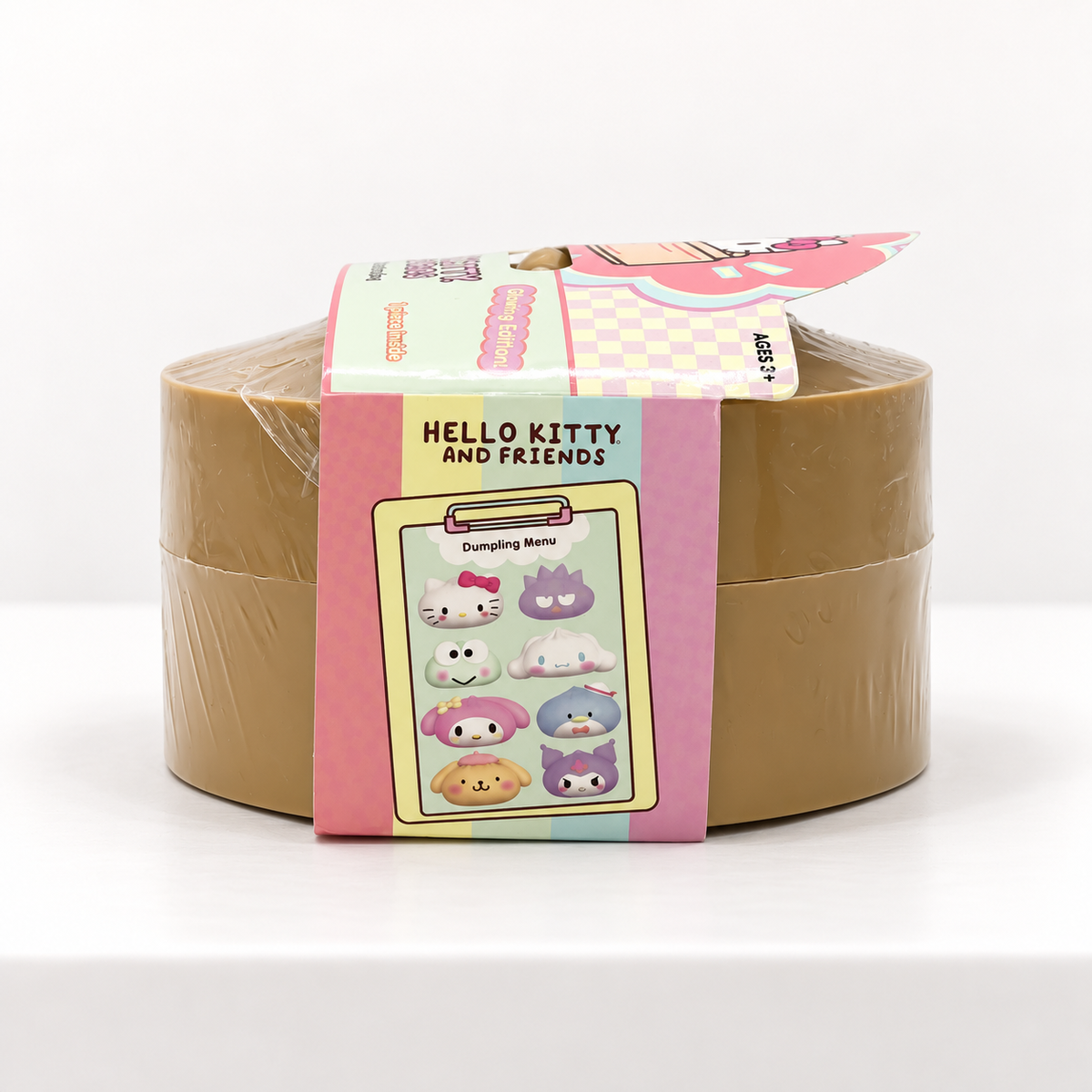 Tan Hello Kitty and Friends Mystery Dumpling container showing pink side wrap
