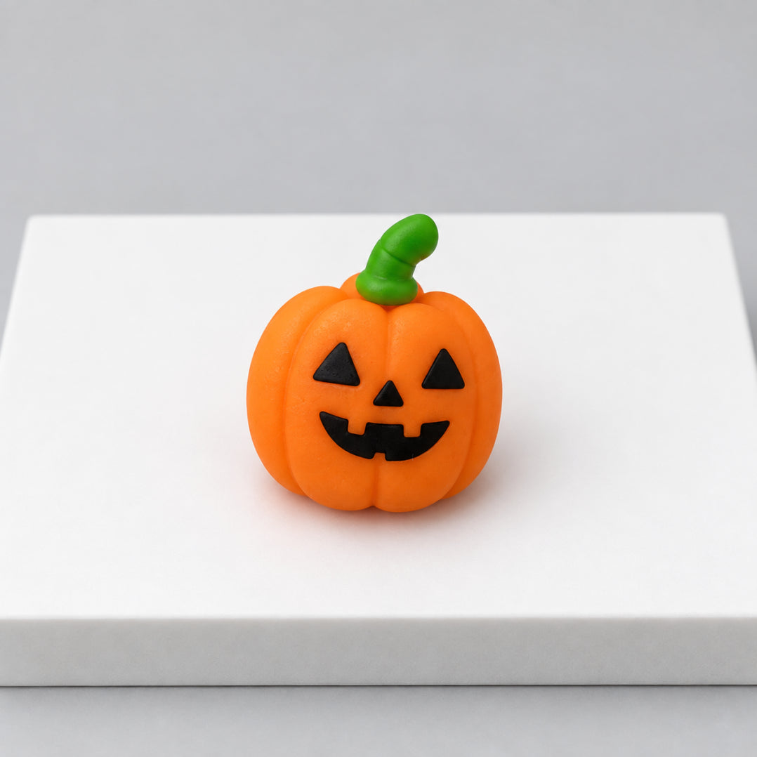 Orange jack-o-lantern Halloween mochi with green stem