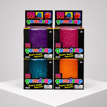 Squish Planet NeeDoh Gumdrop fidget toys in purple, pink, blue, and orange packaging on a white display stand.