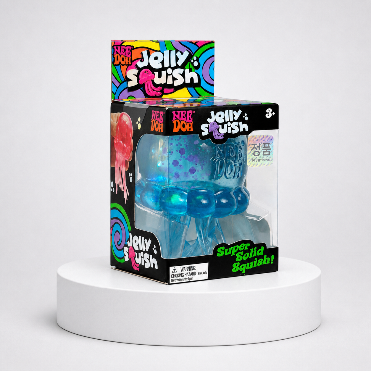 NeeDoh JellySquish blue glitter jellyfish squishy fidget toy in complete retail packaging, centered studio view.