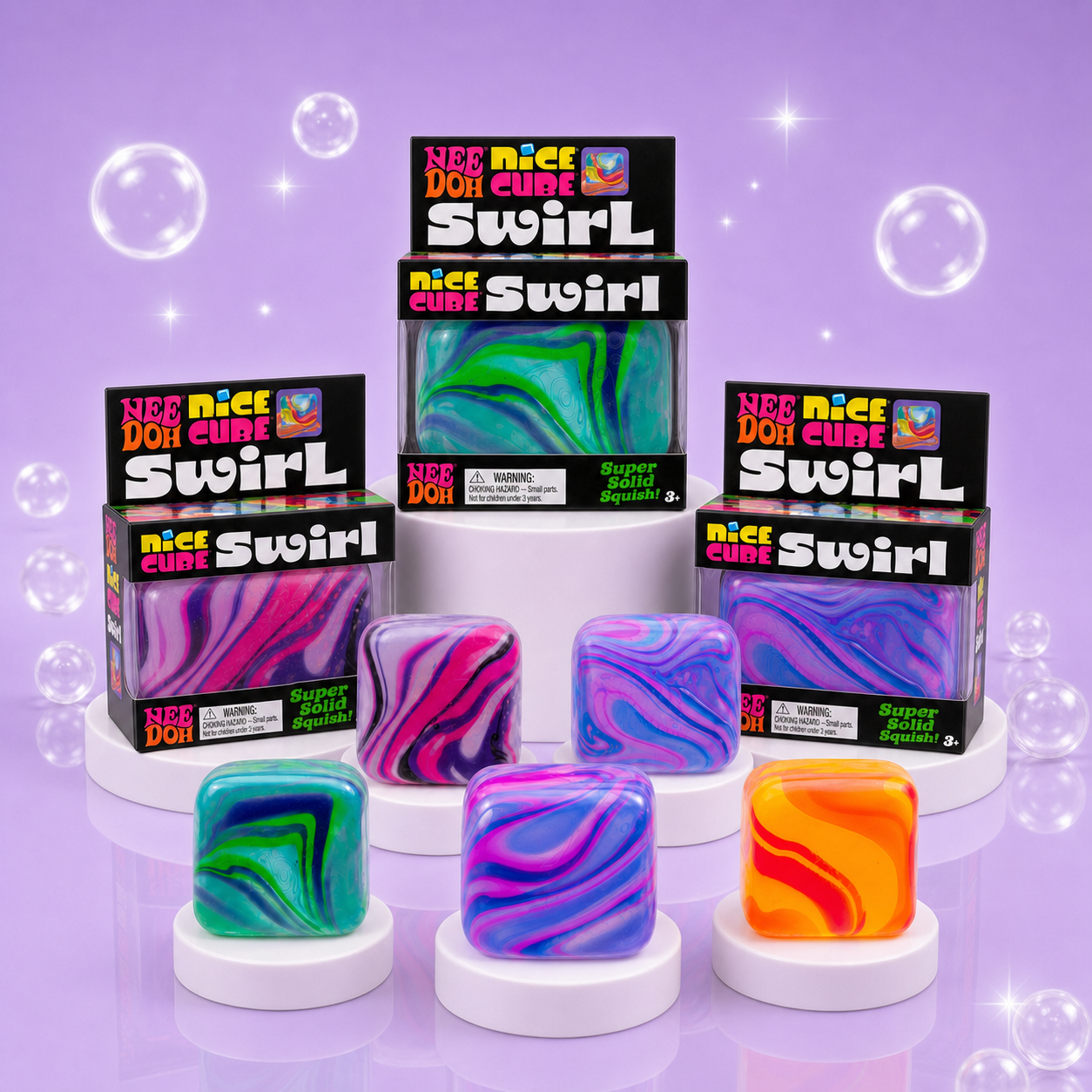 NeeDoh Nice Cube Swirl Super Squeeze packaging with authentic black retail boxes and colorful swirl cube assortment on a Squish Planet purple display.