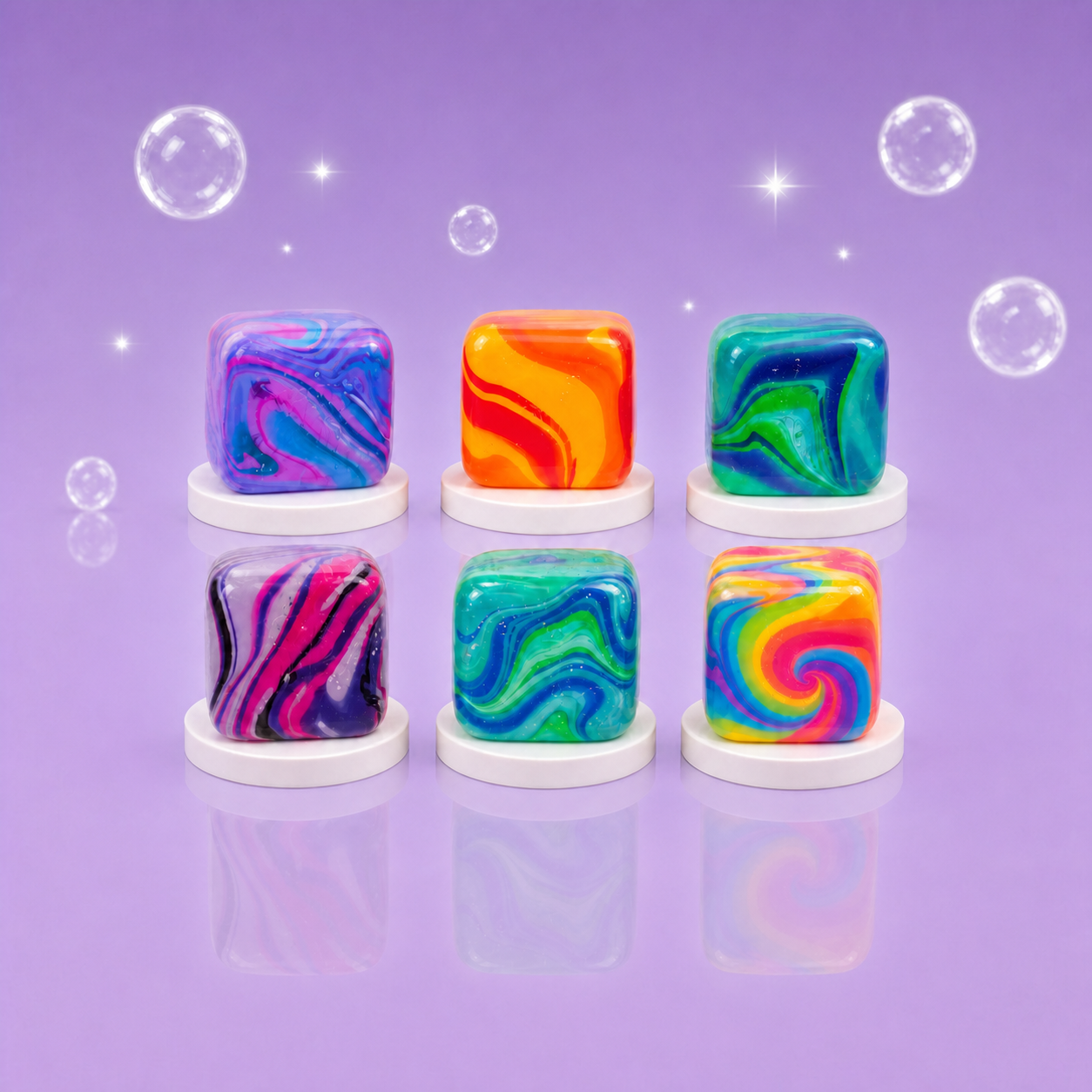 Six NeeDoh Nice Cube Swirl Super Squeeze squishy fidget toys in a centered colorful assortment on a Squish Planet purple display.