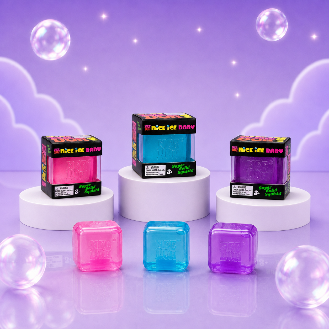 NeeDoh Nice Ice Baby pink, blue, and purple squishy fidget cubes with matching packaging on a Squish Planet purple display.
