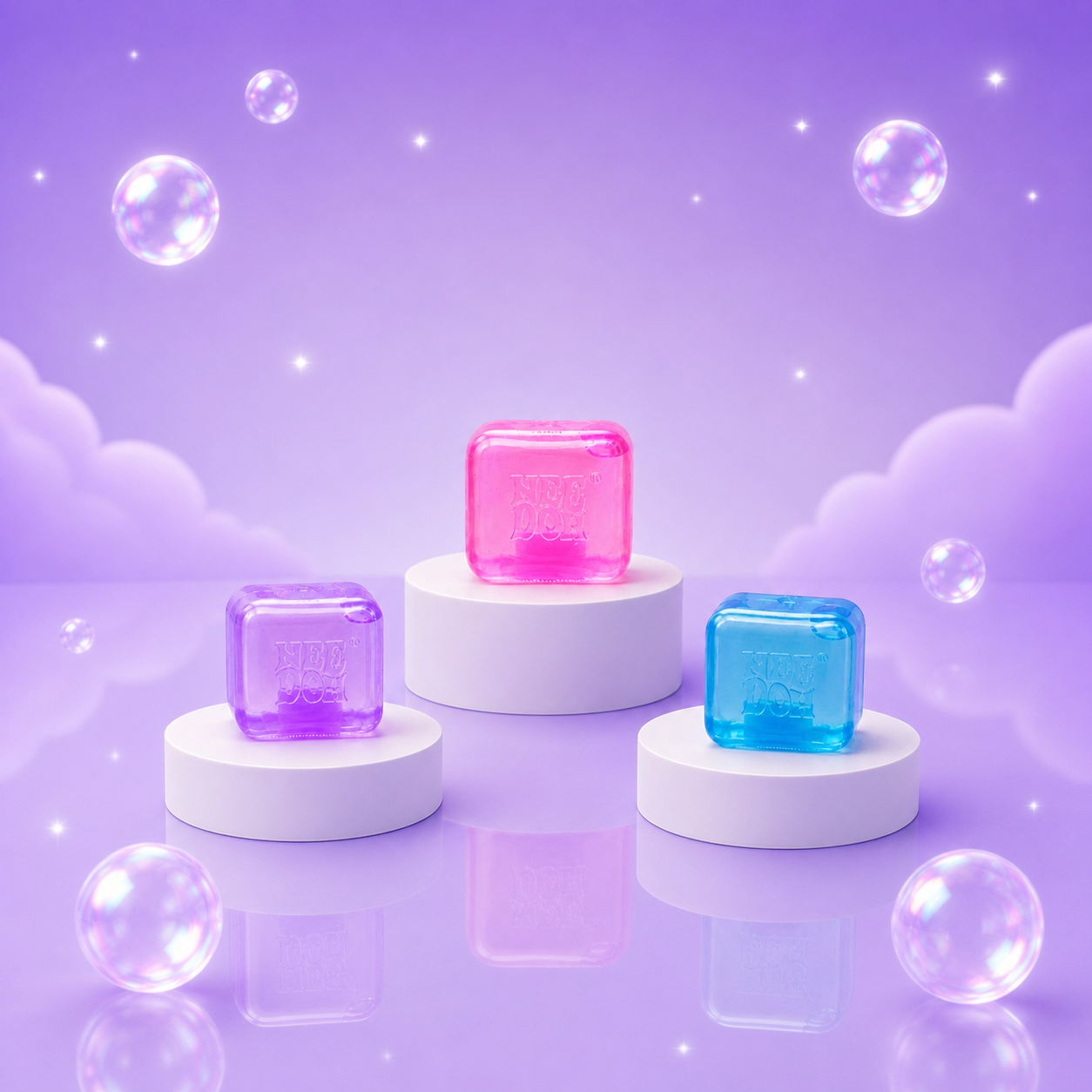 NeeDoh Nice Ice Baby pink, blue, and purple squishy fidget cubes at realistic scale on a Squish Planet purple display.