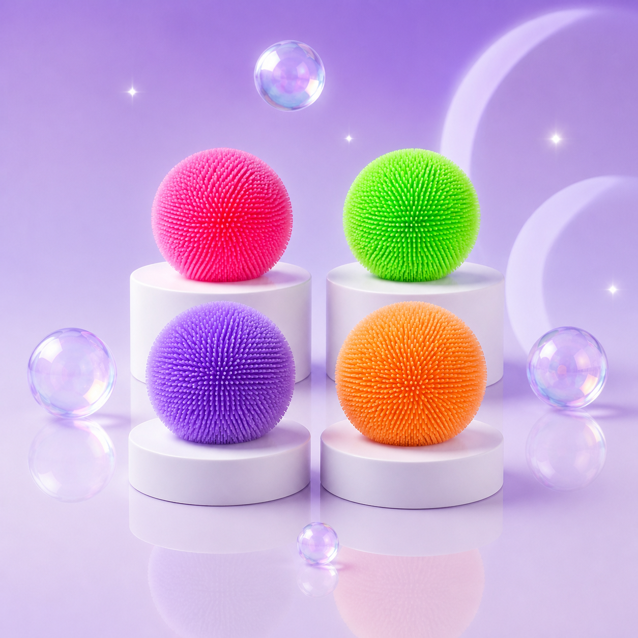 NeeDoh Teenie Fuzz Ball squishy fidget toys in pink, green, purple, and orange on a Squish Planet purple display.