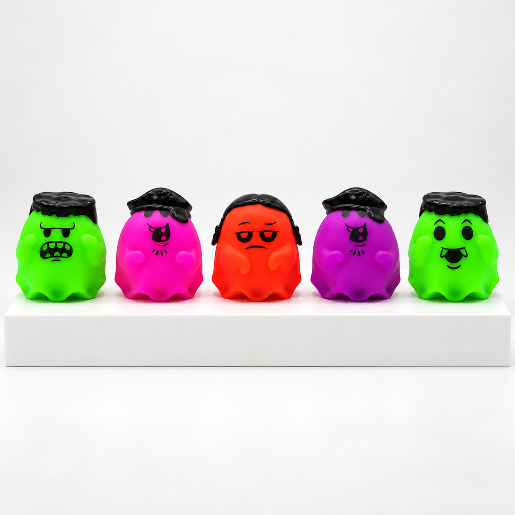 Five unboxed green, pink, orange and purple NeeDoh Glowy Ghost toys in a row