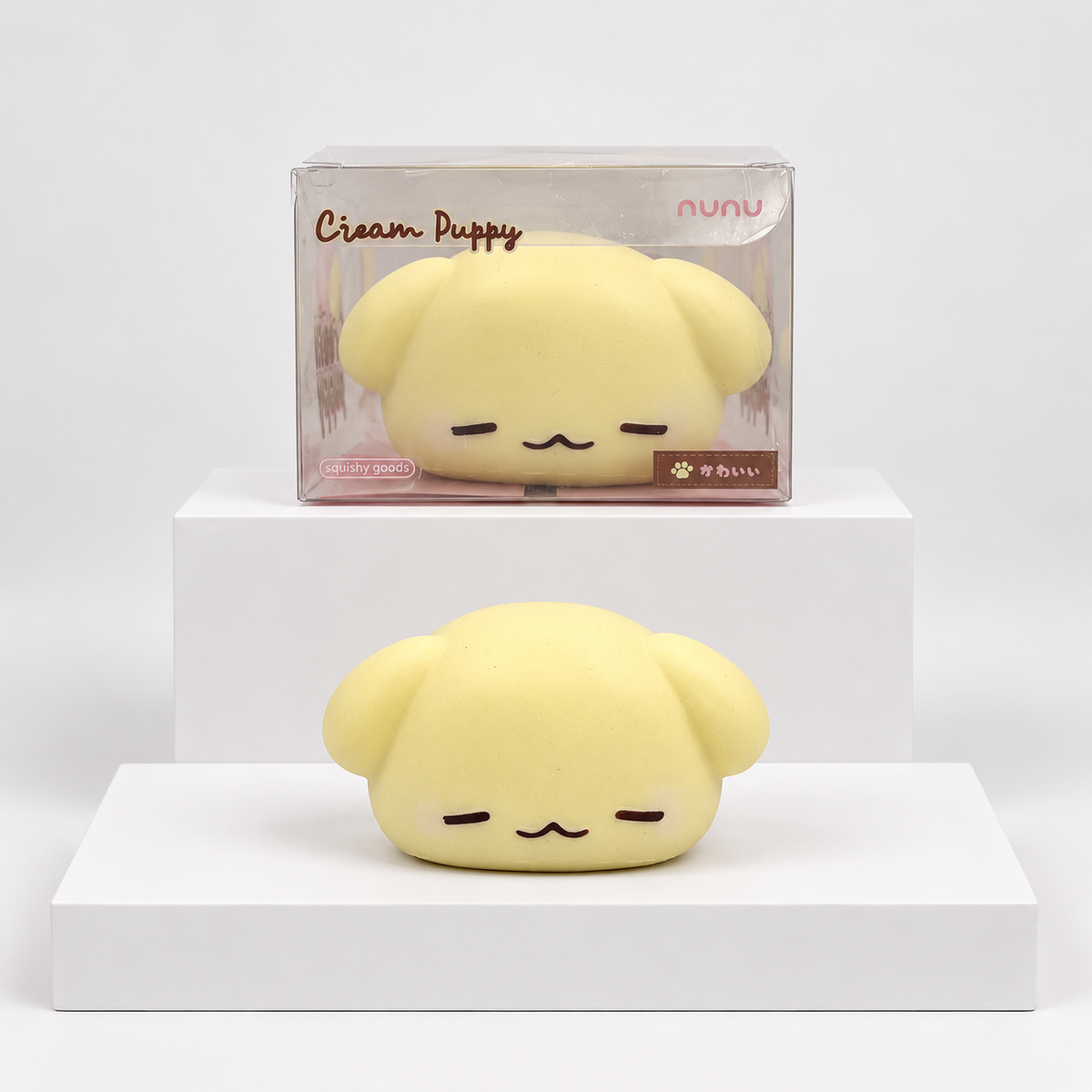 Cream-yellow Nunu puppy character pictured beneath its retail box