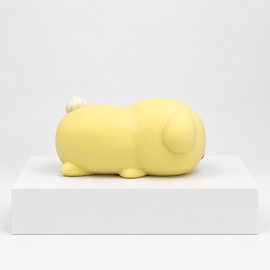 Cream-yellow Nunu puppy character lying down, side view