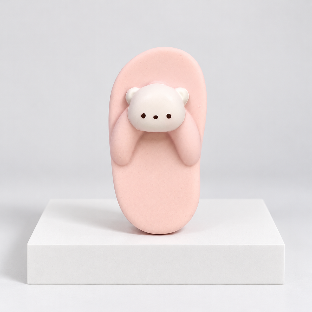 Pink slipper-shaped Nunu toy with white bear face, front view