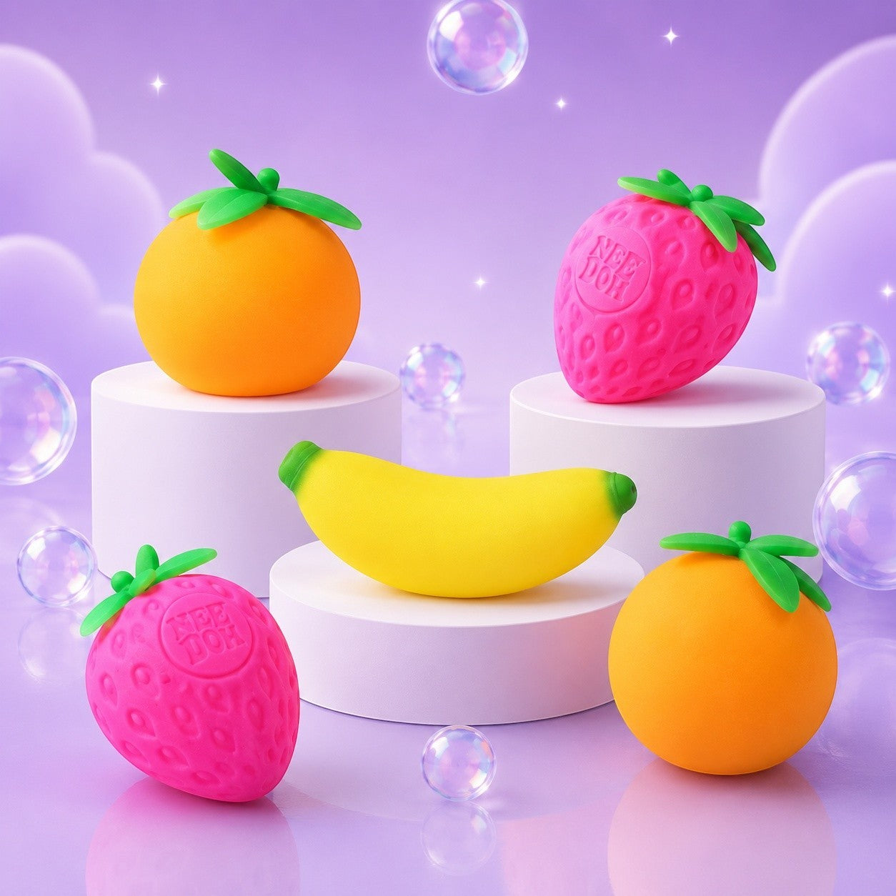 Squish Planet NeeDoh Groovy Fruit multicolor squishy fidget toys shaped like strawberries, oranges, and a banana.
