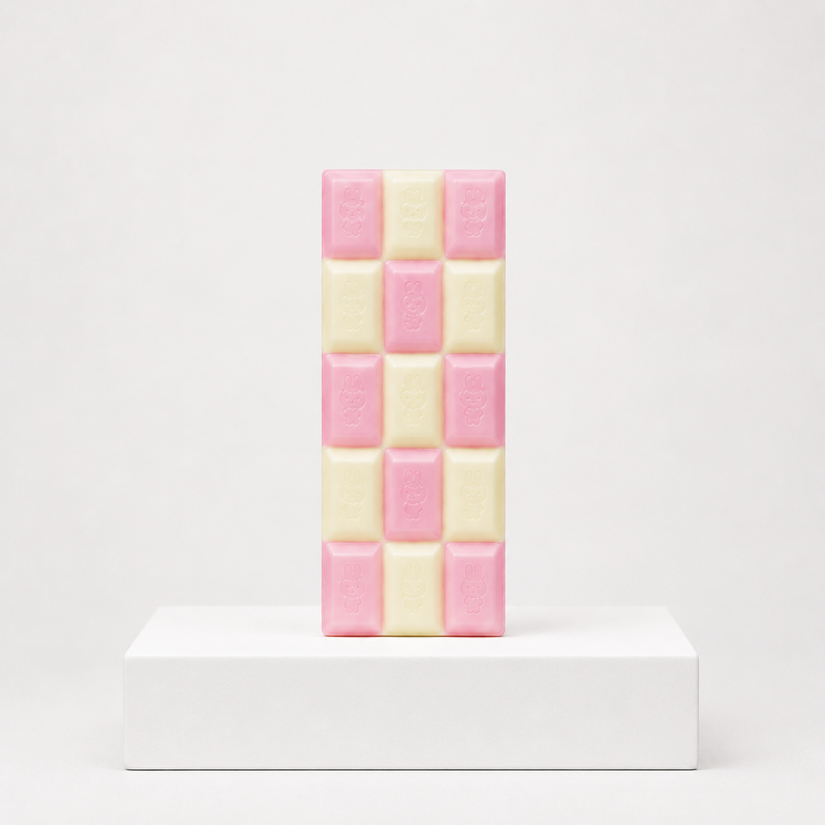 Pink and white checkerboard chocolate-bar squishy with embossed characters