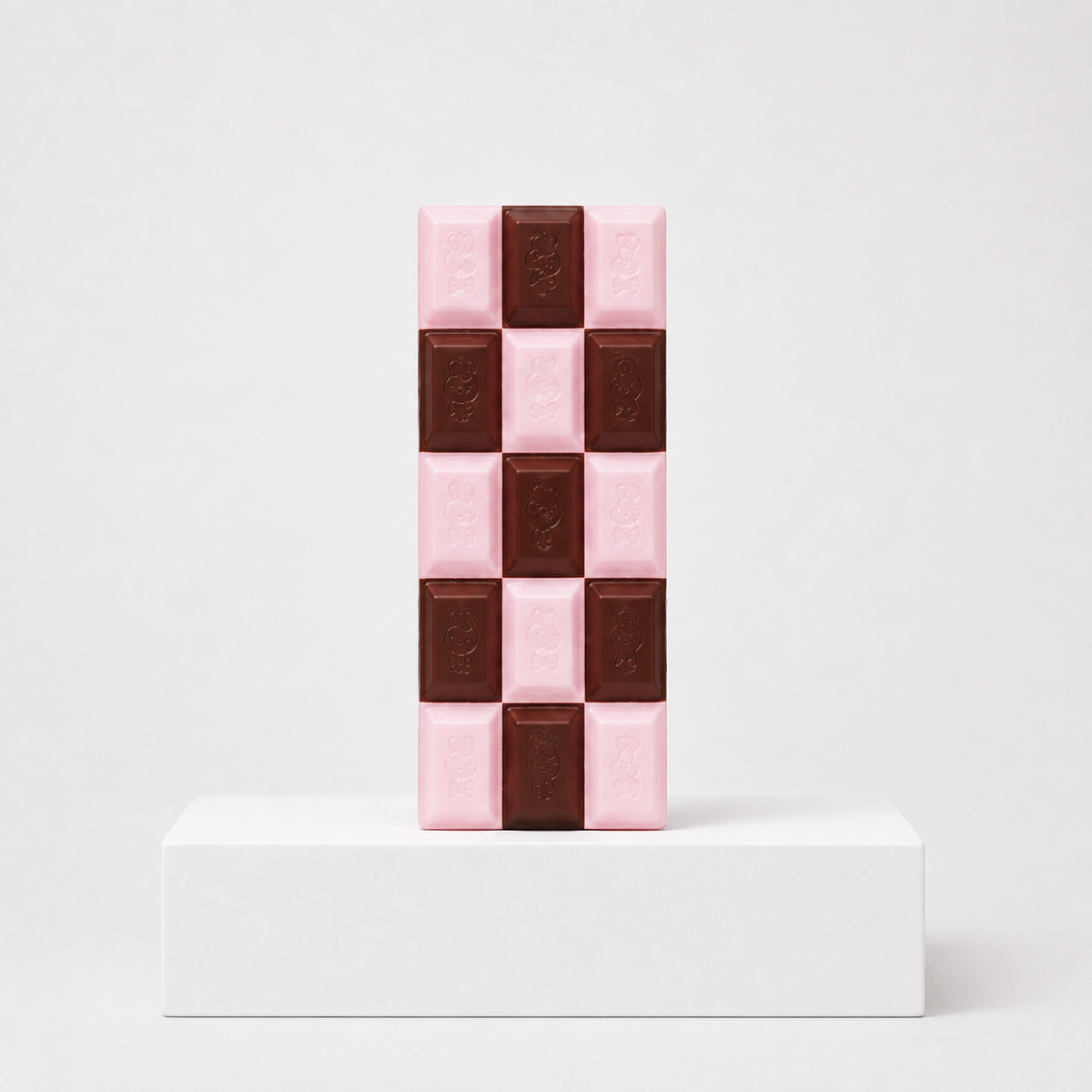 Pink and dark brown checkerboard chocolate-bar squishy with embossed characters