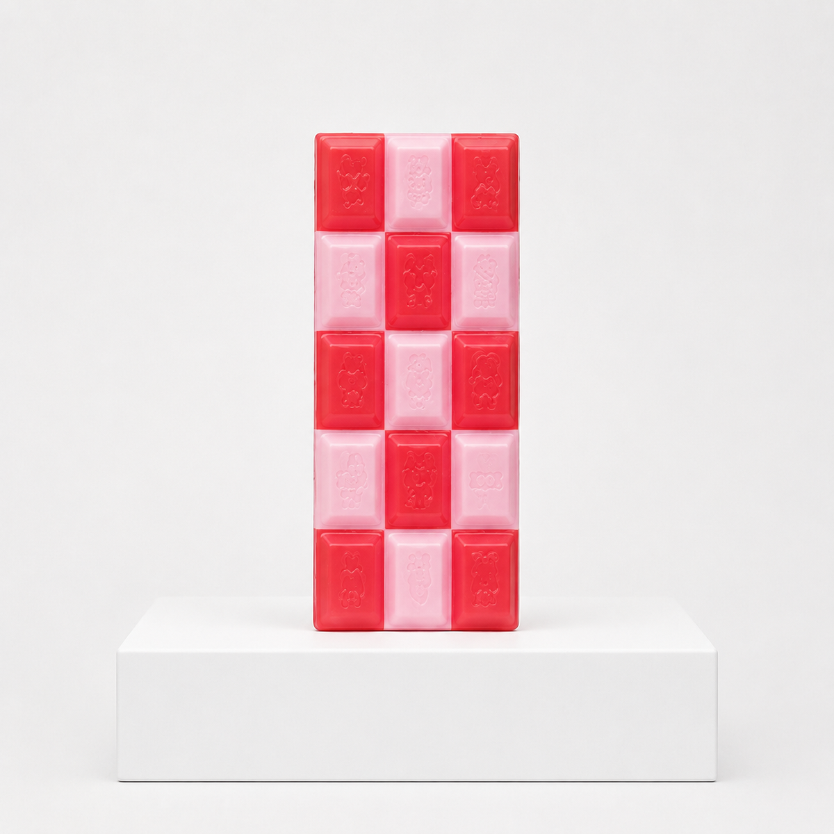 Red and pale pink checkerboard chocolate-bar squishy with embossed characters