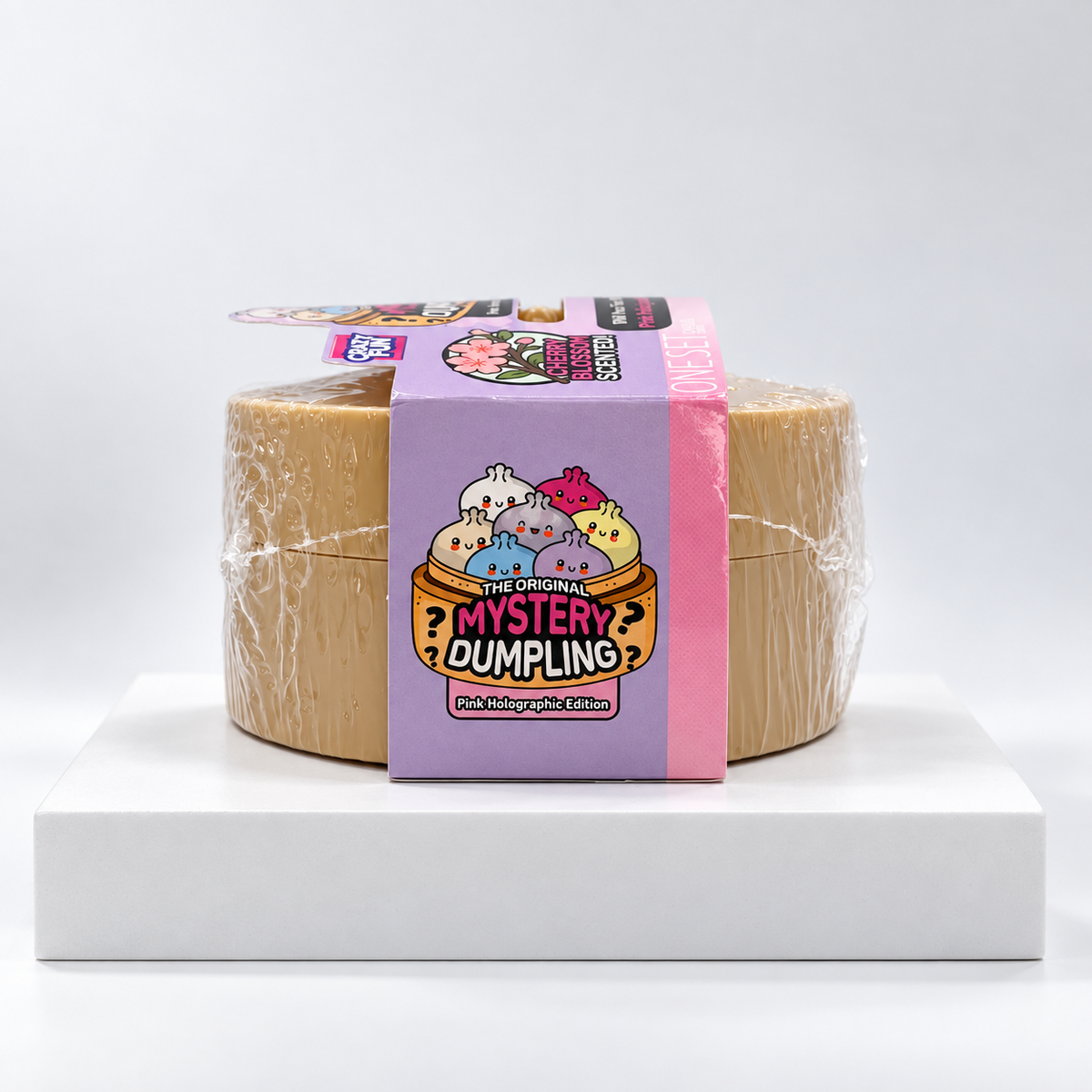Crazy Fun Mystery Dumpling round package with pink band, side view