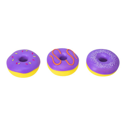 Squish Planet NeeDoh Dohnuts squishy fidget toys in purple with yellow bases. One has pink and yellow sprinkles, another orange icing, and the third white sprinkles.