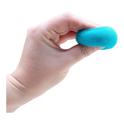Squish Planet NeeDoh Teenie Fuzz Ball, a small blue textured squishy fidget toy held in a hand.