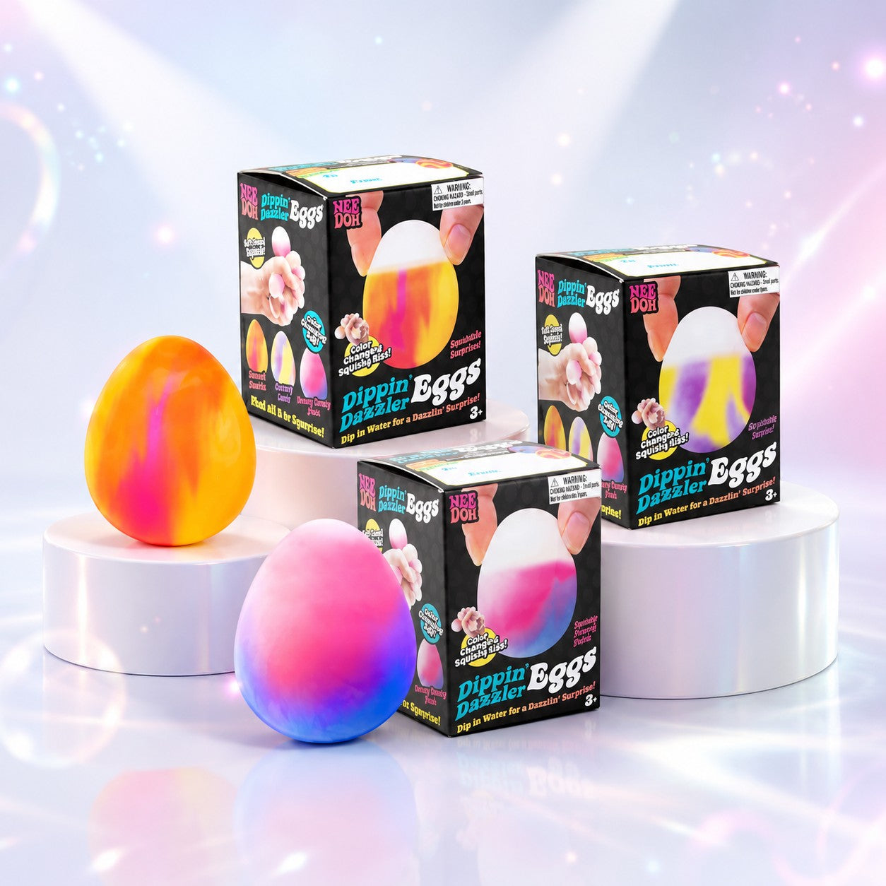 Squish Planet NeeDoh Dippin Dazzler color-changing egg fidget toys with marbled designs on white display pedestals.