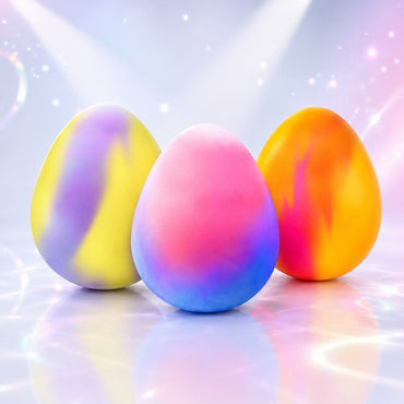 Squish Planet NeeDoh Dippin Dazzler egg fidget toys in vibrant marbled colors on a reflective surface.