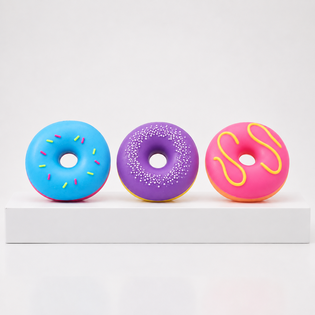 Three loose NeeDoh Dohnuts in blue, purple and pink