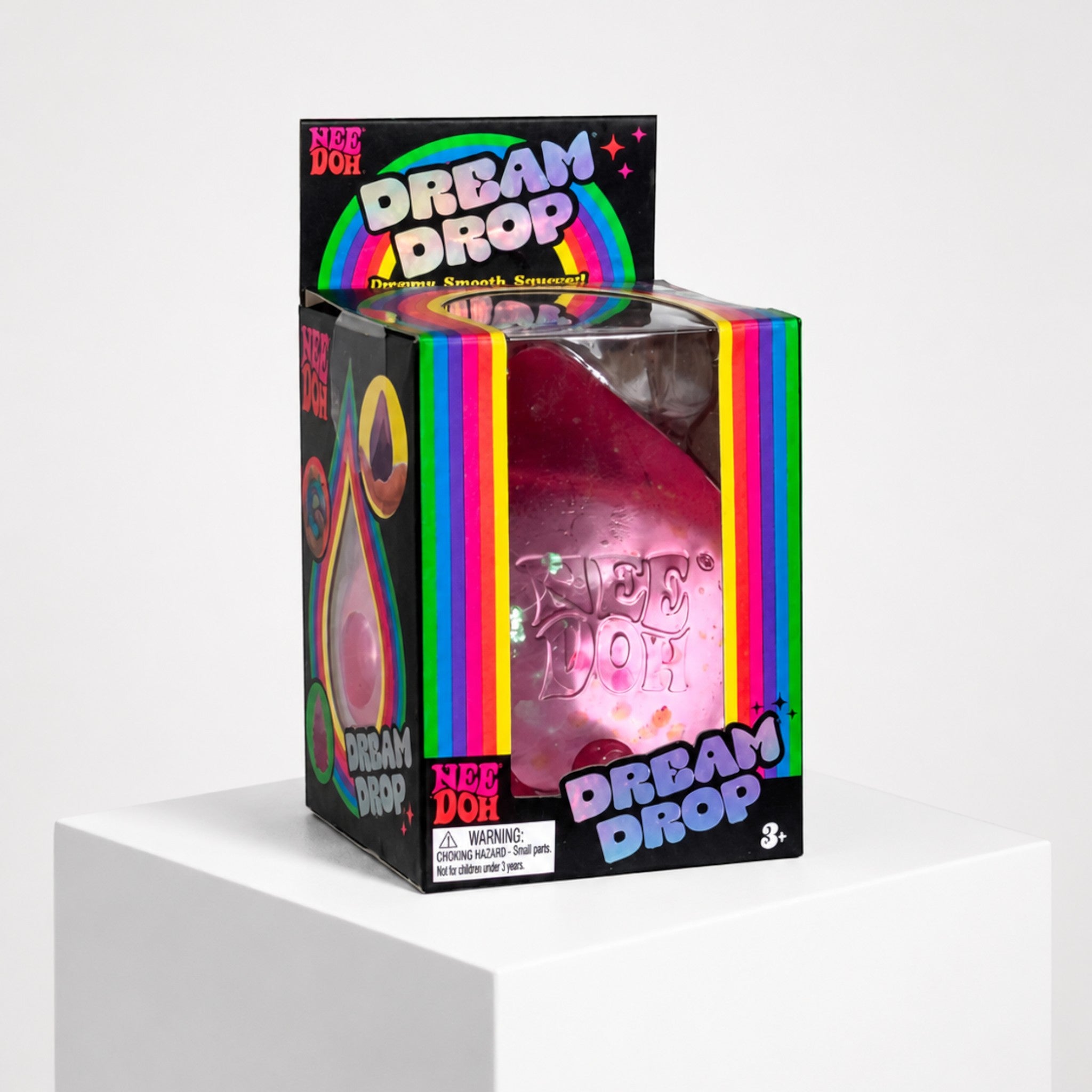 Squish Planet NeeDoh Dream Drop squishy fidget toy in its colourful retail packaging on a white display pedestal.