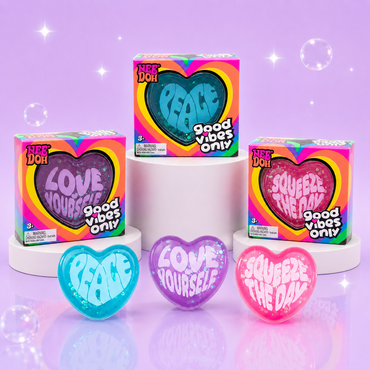 NeeDoh Good Vibes Only blue, purple, and pink heart squishy fidget toys with matching retail packaging.