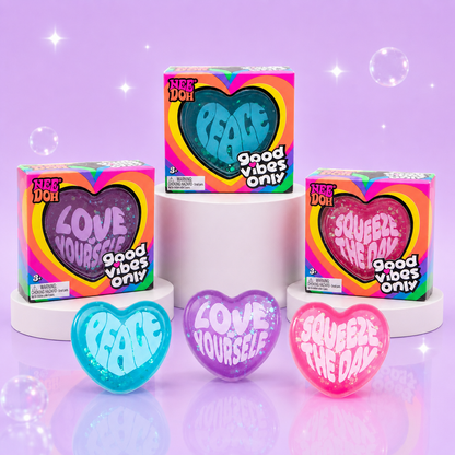 NeeDoh Good Vibes Only blue, purple, and pink heart squishy fidget toys with matching retail packaging.