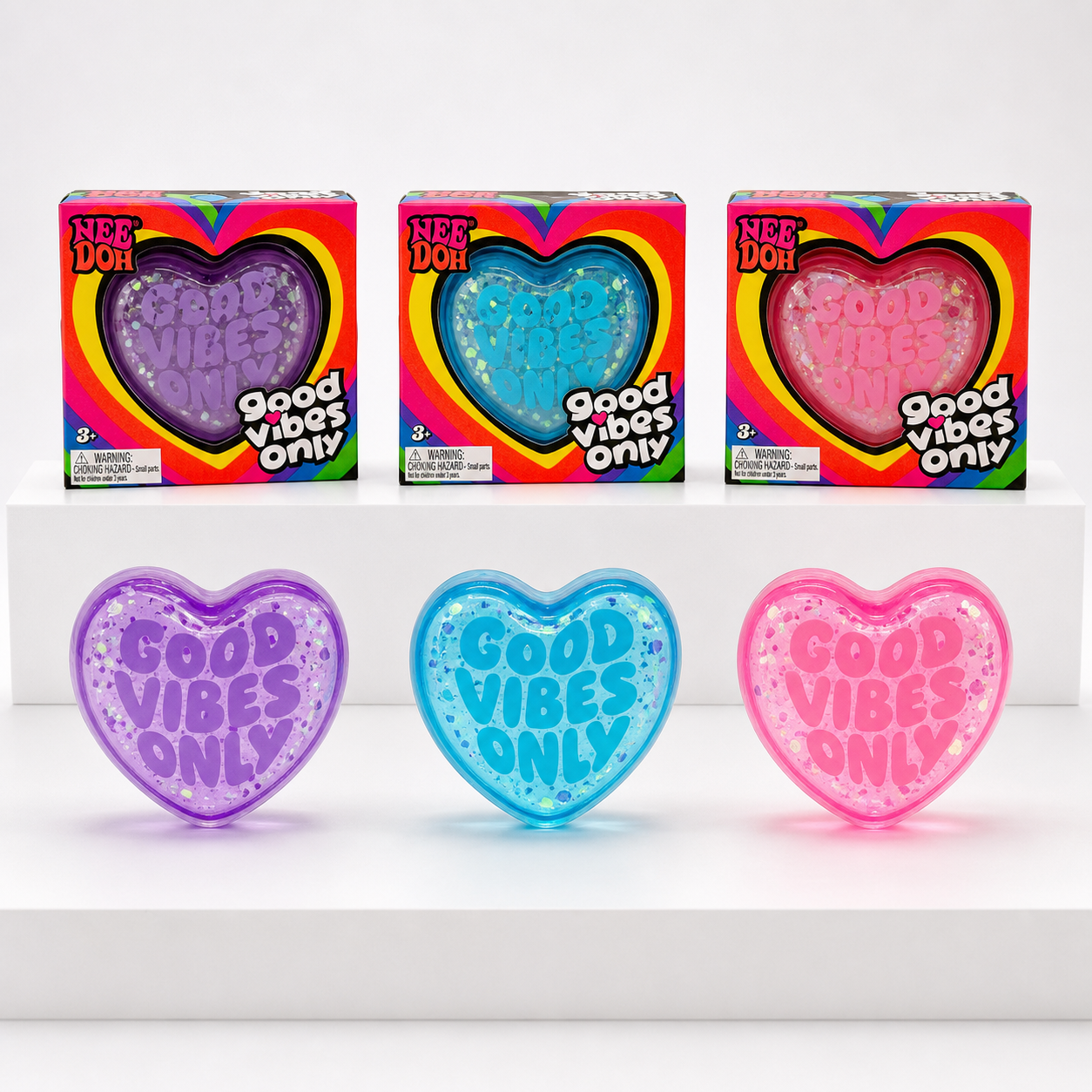 NeeDoh Good Vibes Only Purple, Blue, and Pink heart squishies with matching retail packages.