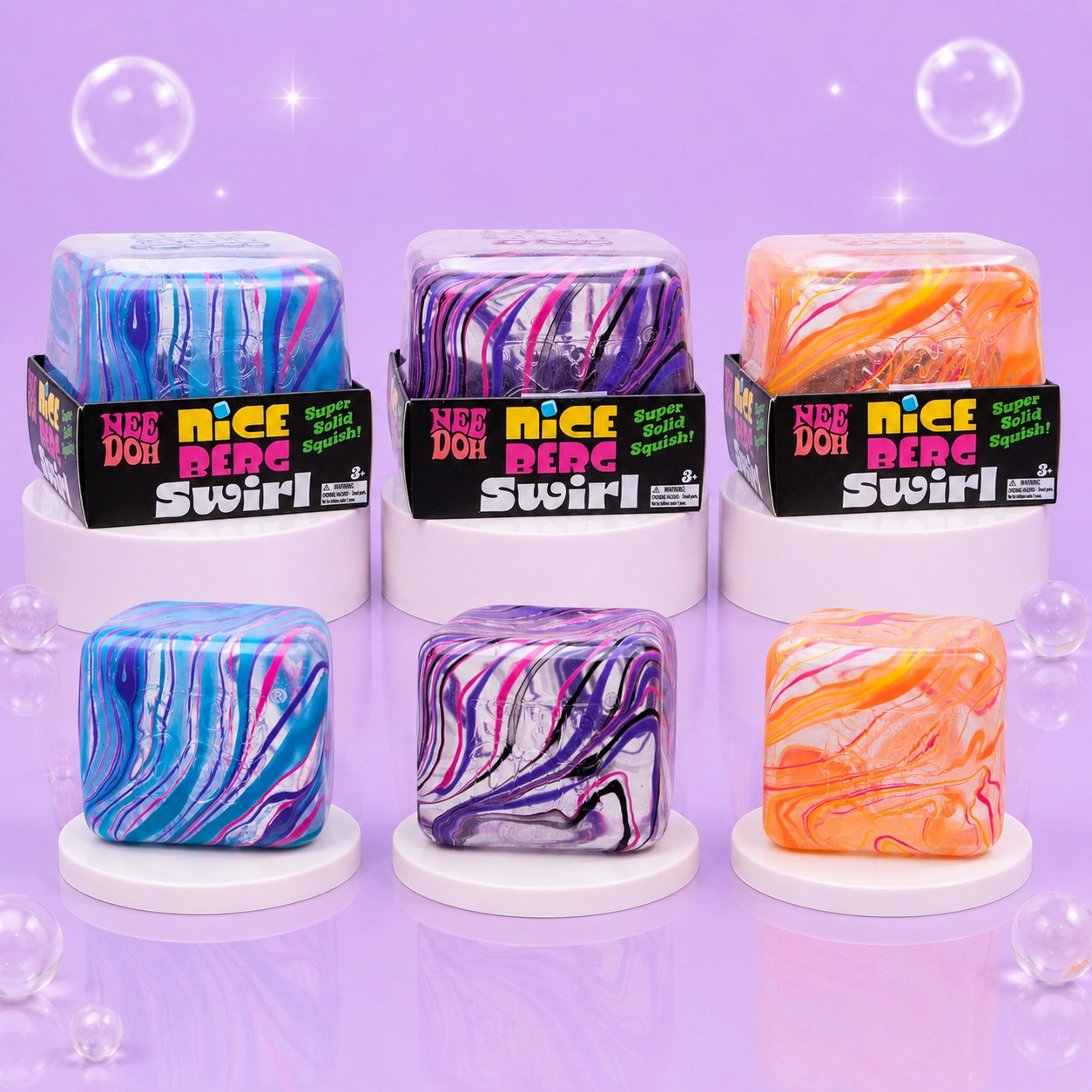 Squish Planet NeeDoh Jumbo Swirl Nice Berg fidget toys in blue, purple, and orange marble patterns on white pedestals.