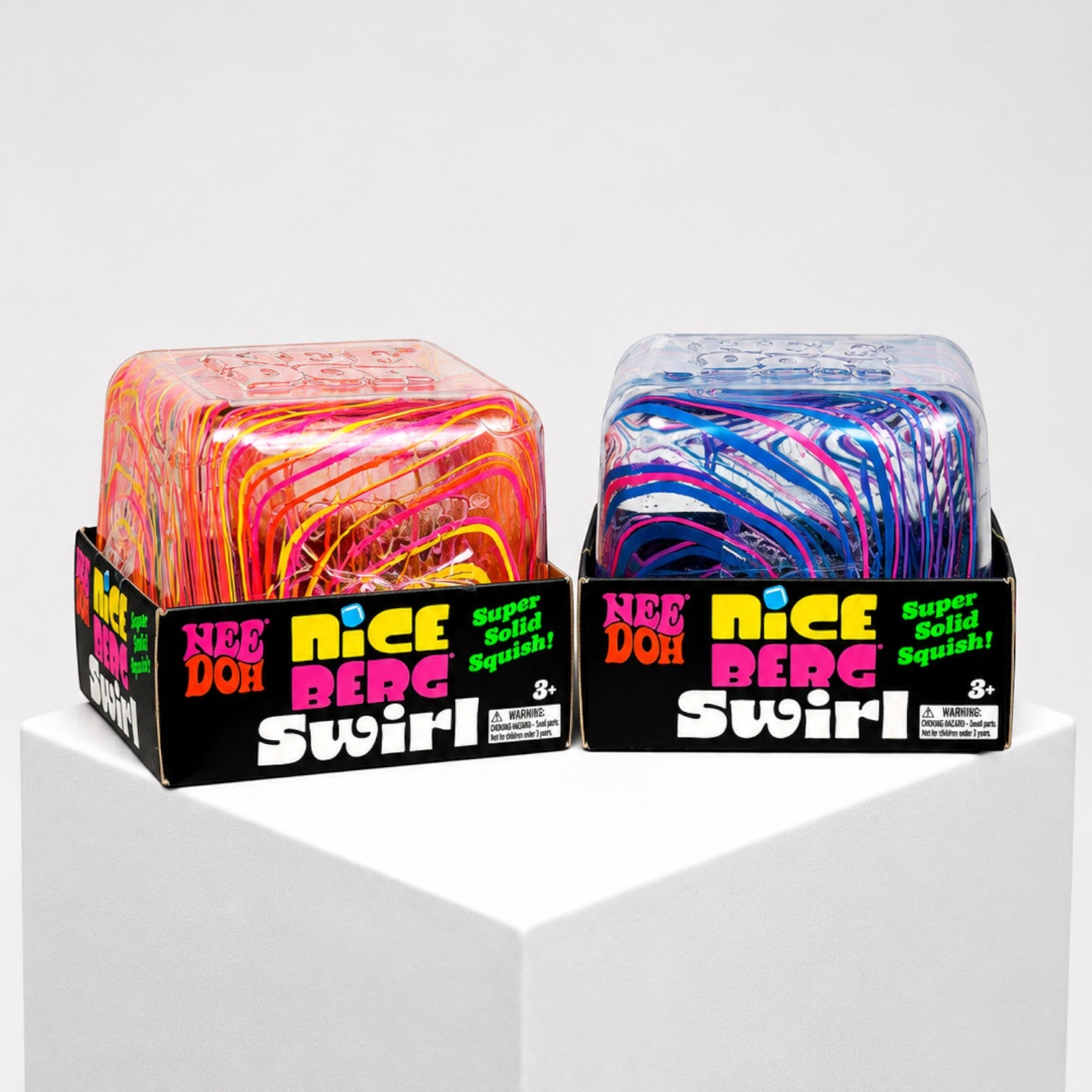 Squish Planet NeeDoh Jumbo Swirl Nice Berg fidget toys in orange and blue multicolor swirl designs on display.