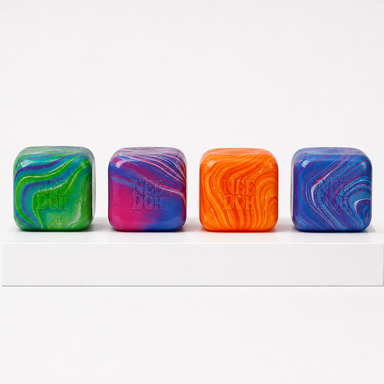 Four loose NeeDoh Nice Cube Swirl toys in green, pink, orange and blue