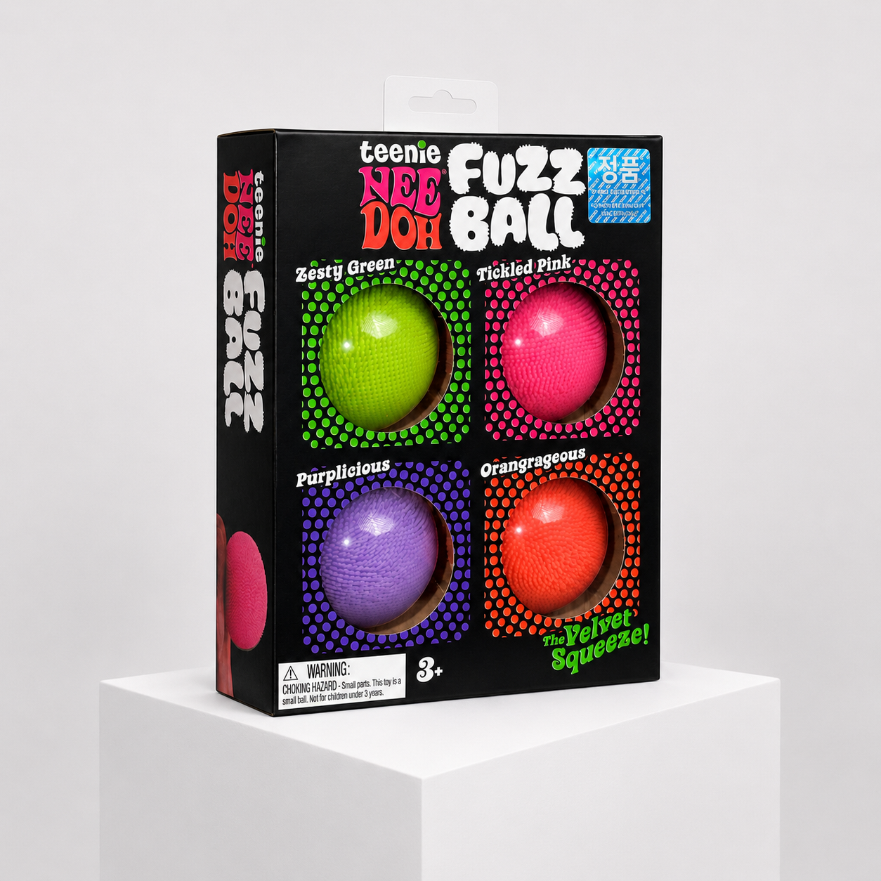 NeeDoh Teenie Fuzz Ball Pack of 4 with green, pink, purple, and orange squishy fidget toys in complete retail packaging.
