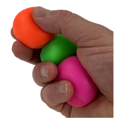 Squish Planet three-pack of neon sensory stress balls in orange, green, and pink, held in a hand.
