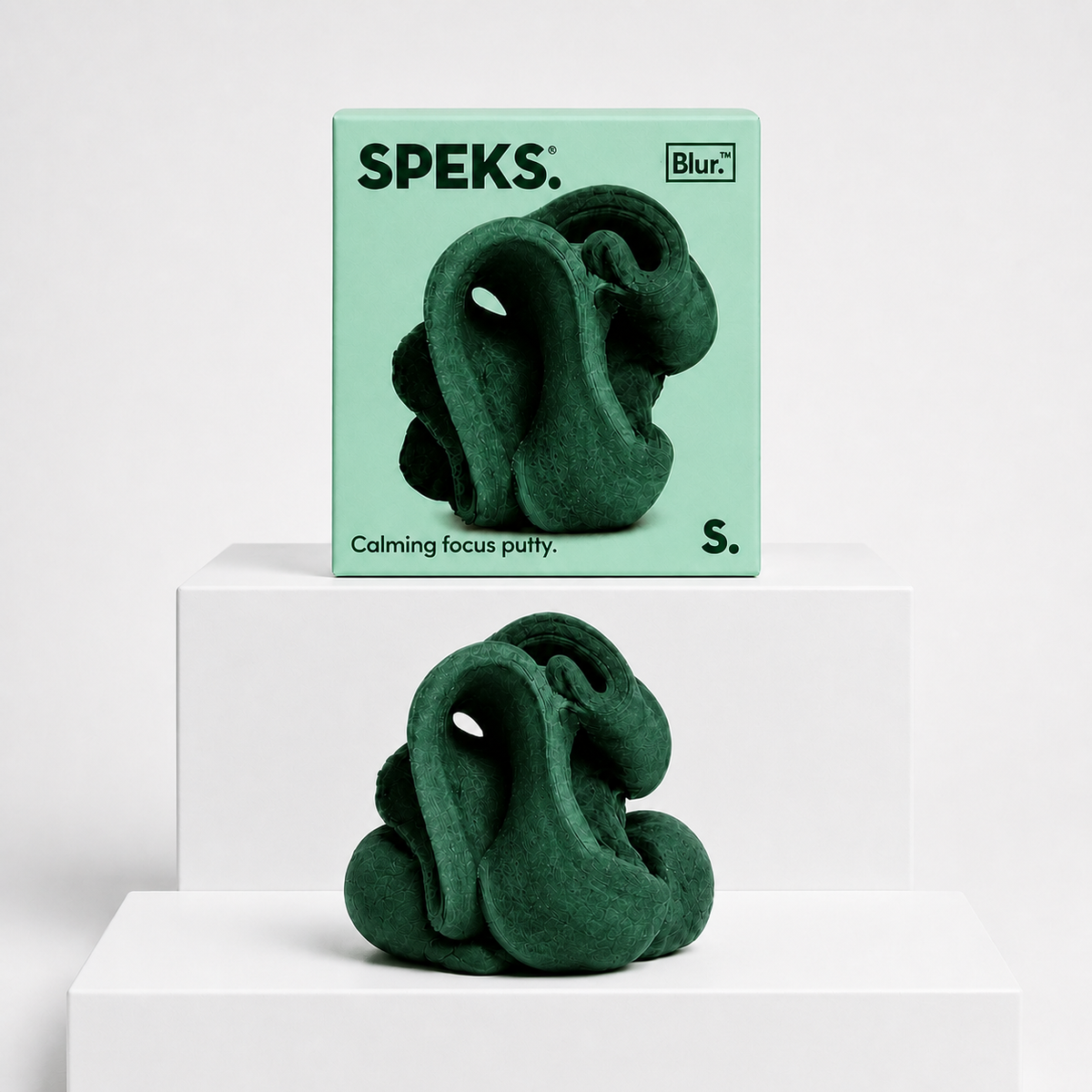 Forest green Speks Blur Focus Putty with matching box on a neutral white studio background